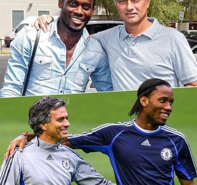 A photo of three Chelsea legends — Michael Essien, Jose Mourinho, and Didier Drogba — standing together during their time at Chelsea. Mourinho is in a suit, while Essien and Drogba wear Chelsea training kit. All three are smiling, celebrating a victory.